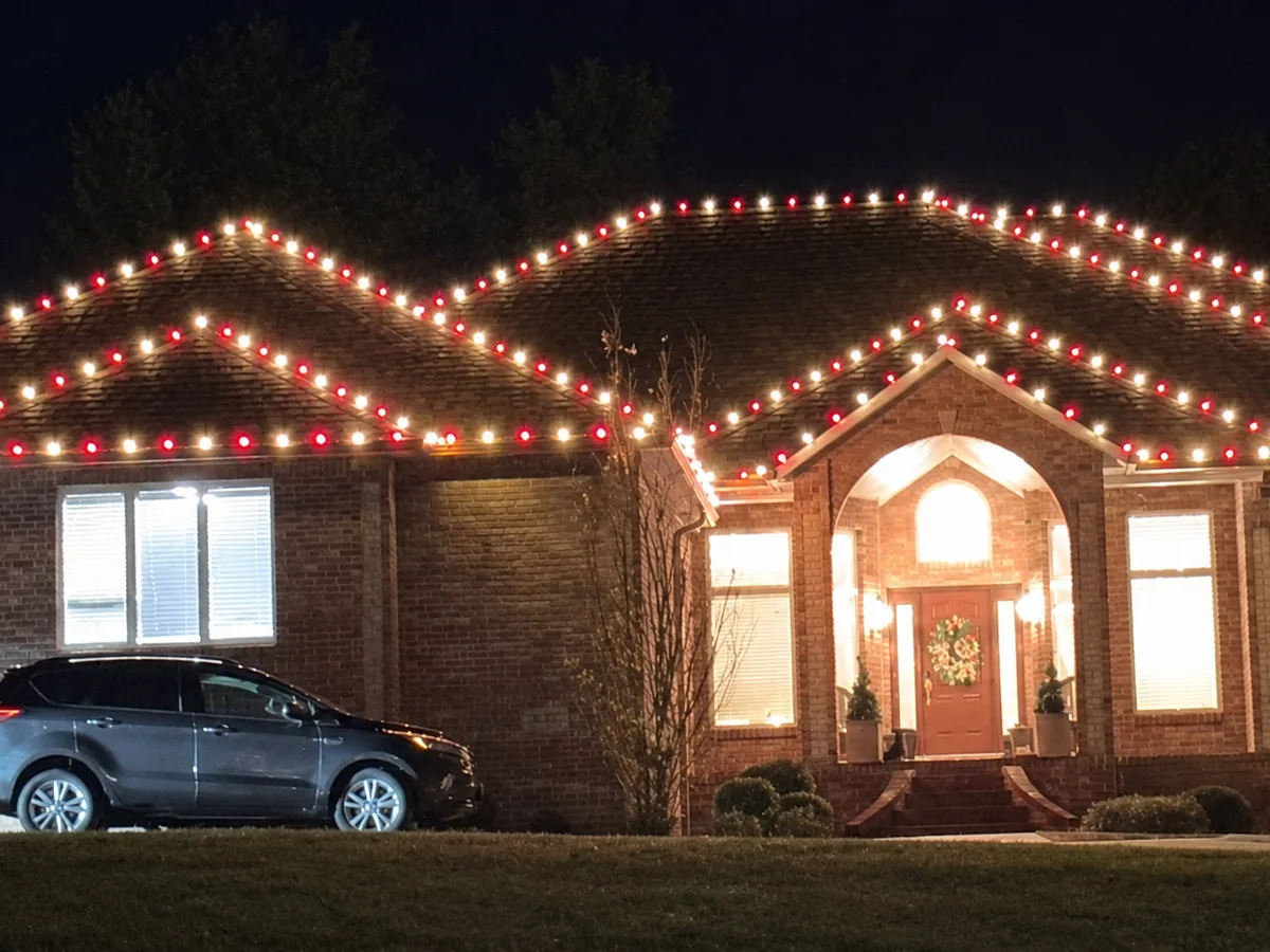 Brick home with warm roofline lighting